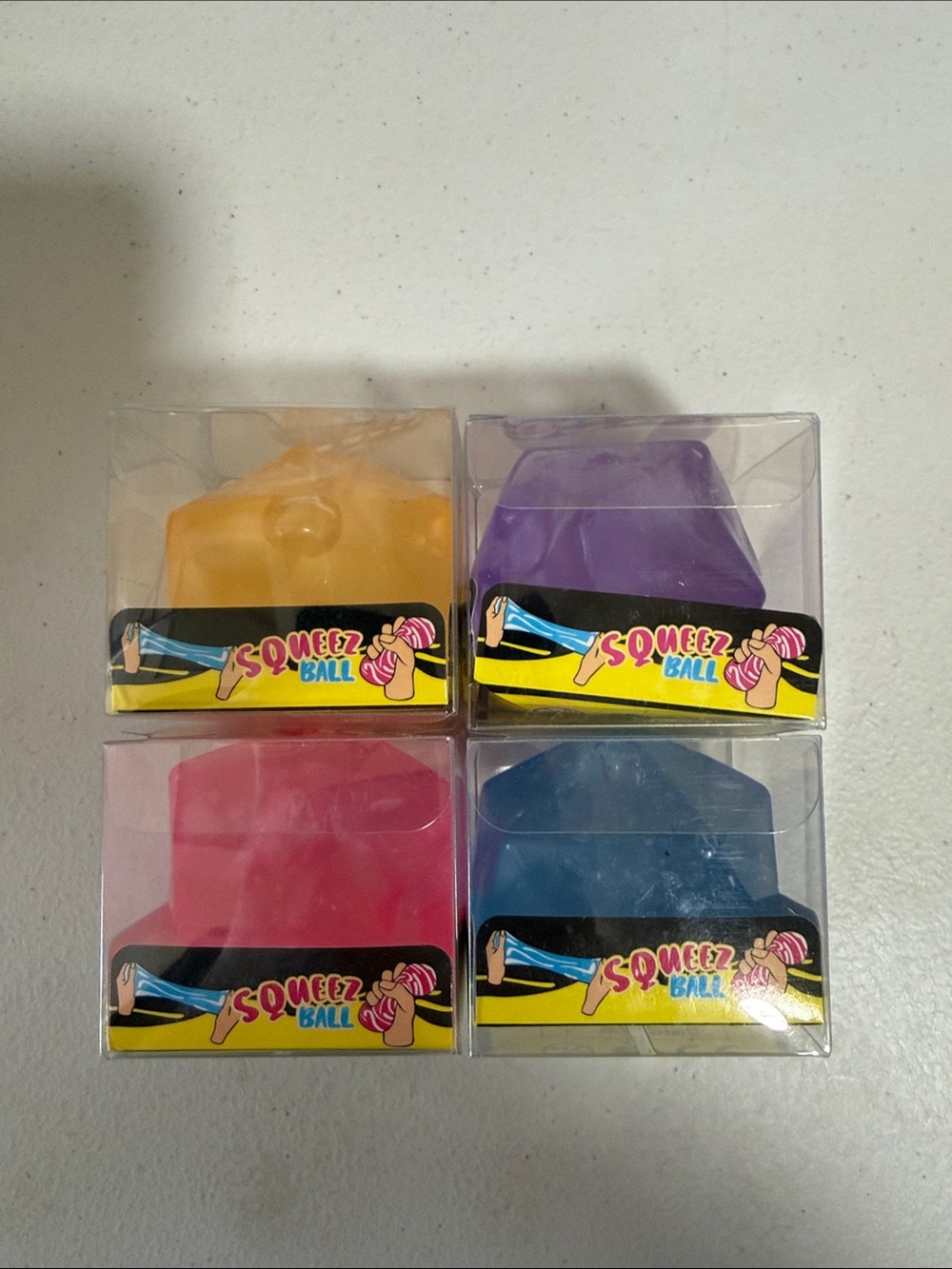 Squeezy Squeez Ball Set of 4 Yellow, Purple, Pink, Blue
